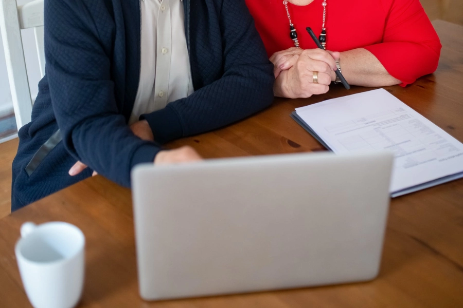 happy couple with a clipboard researching the different type of deductibles in medical insurance