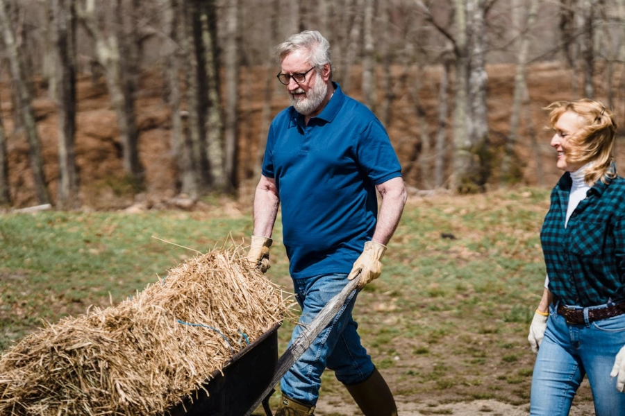 Older man daily activity of moving some hay